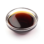 Dark caramel syrup, isolated on white background.